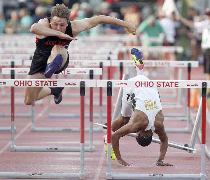 Akron Firestone's Kevon Louis tumbles over the second to last hurdle alongside Ashland's Hudson McDaniel during the Division I, 110 meter hurdles at the OHSAA State Track and Field Tournament at Jesse Owens Memorial Stadium in Columbus.   (Leah Klafczynski / Akron Beacon Journal)